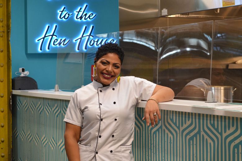 Brandi Artis, chef-owner of 4 Hens Creole Kitchen, poses at her stall in the Food Hall at City Foundry. 
