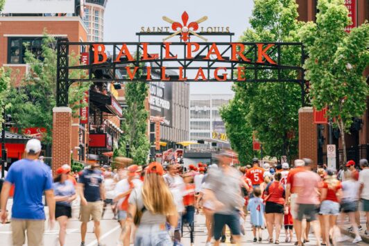 People mill about Ballpark Village in St. Louis.