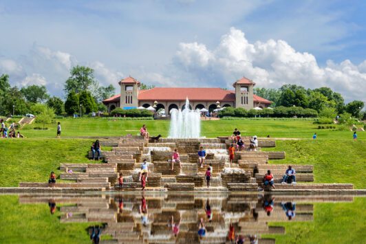 People play in the fountain in front of the World's Fair Pavilion in Forest Park.