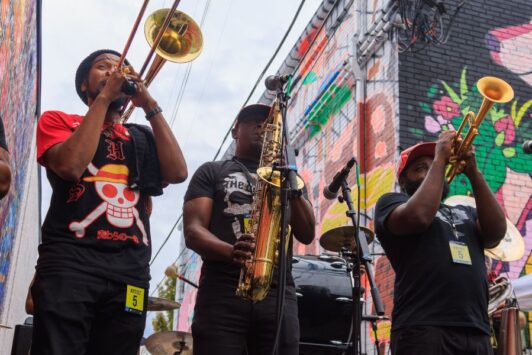 A brass band plays among the murals of Grand Center during Music at the Intersection, which features some of the best summer concerts in St Louis.