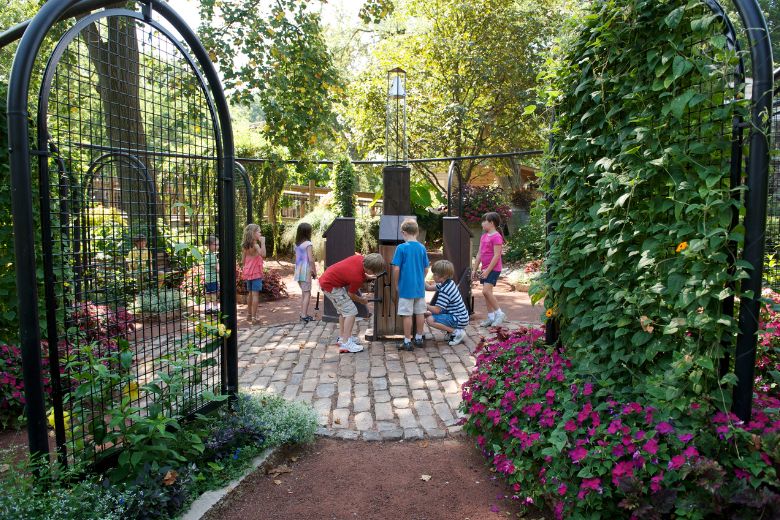 A group of kids interact with the plants at the Missouri Botanical Garden.
