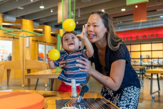 A mother and her young son make balls float in the air at the Saint Louis Science Center.