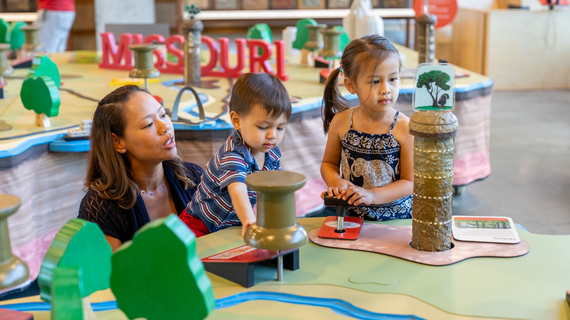 A family with young kids plays at the Saint Louis Science Center.