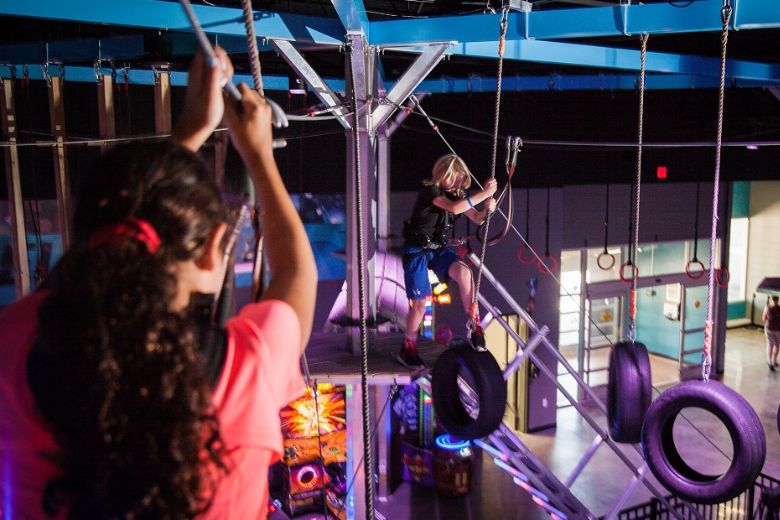 Kids play on the elevated ropes course at Amp Up Action Park.