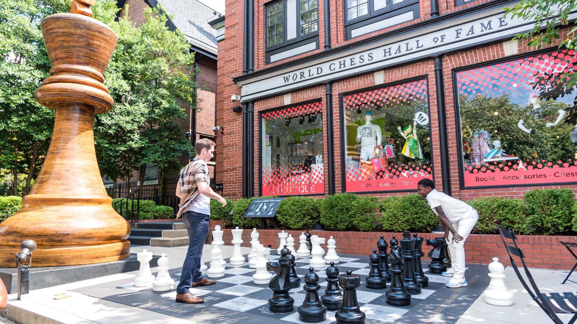 Kids play giant chess outside the World Chess Hall of Fame.