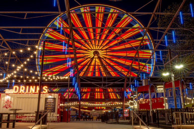 The St. Louis Wheel lights up at St. Louis Union Station at night.